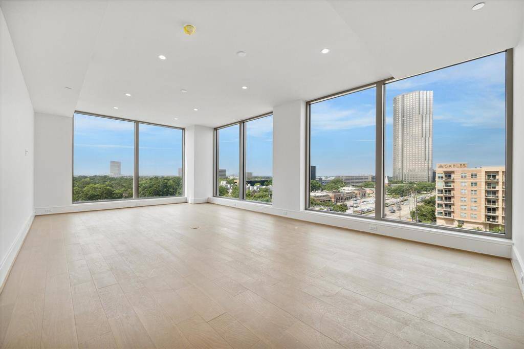 Experience the seamless blend of indoor-outdoor living in the open living/dining space, adorned with floor-to-ceiling windows. Natural light floods the room.