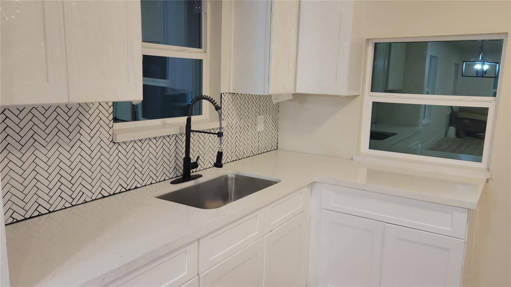 Beautiful white matching backsplash, with plenty of counter space.
