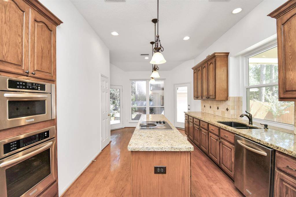 Electric stovetop on the kitchen island.  Stainless steel appliances!