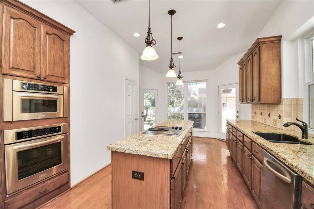 At the end of the kitchen is an eating area with another door that leads to the covered car port.