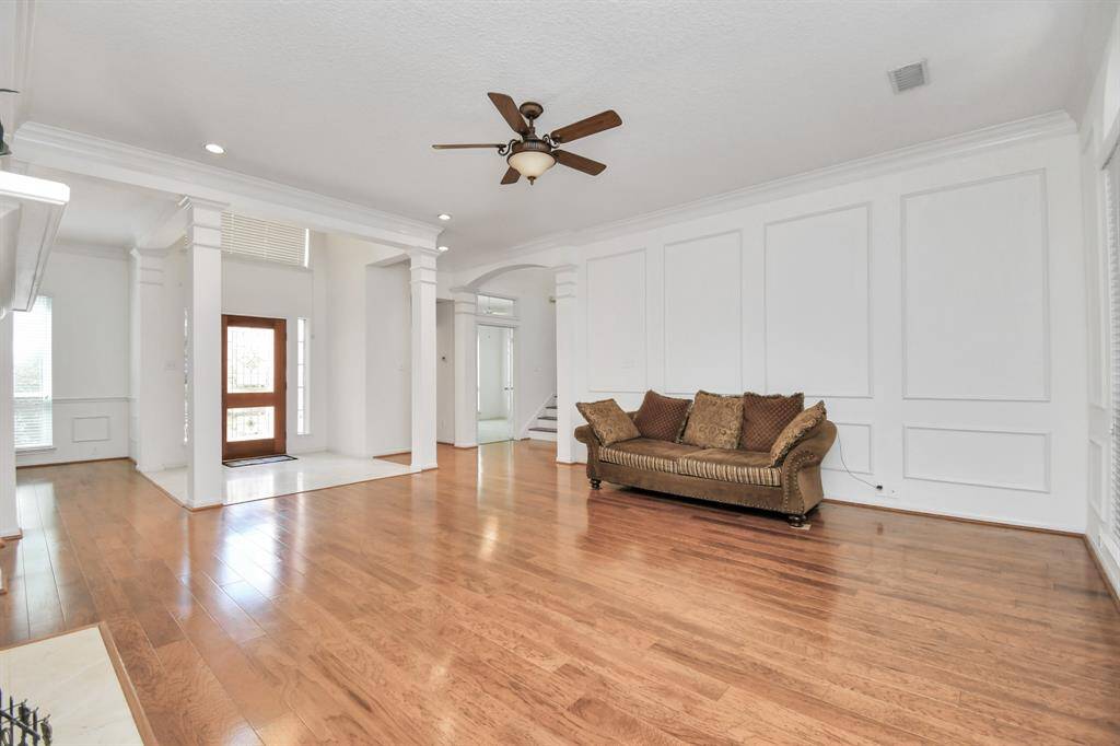 One of two entries from the kitchen into the expansive living area with beautiful wood flooring!
