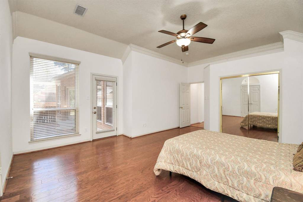 Walk in closet and door leading out to the back patio in the primary bedroom!