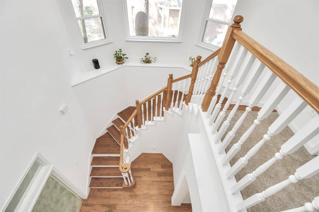 Going upstairs has a beautiful curved stairway.  Notice the windows that let in natural light!