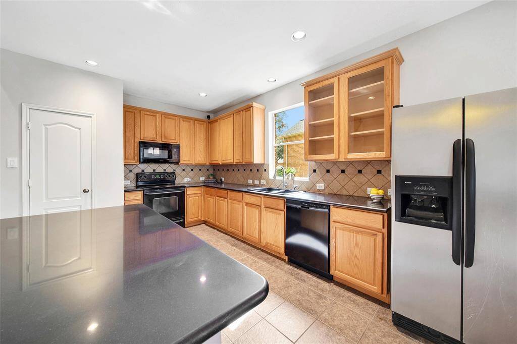 Elegant light maple cabinetry with stylish glass accents.