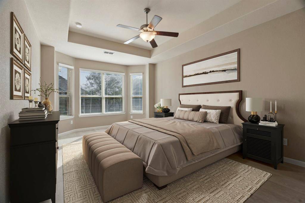 MASTER BEDROOM - Vualted ceilings and bay windows add to the charm of the master suite! (Virtually Staged)