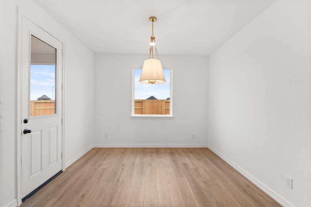 With an abundance of natural light streaming through the windows, the breakfast nook is bathed in a sunny glow, creating the perfect atmosphere to enjoy your morning coffee or a family breakfast.