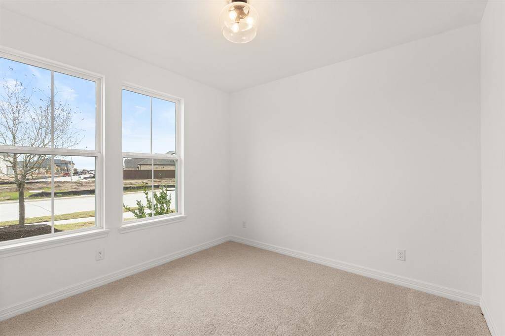 Your secondary bedroom features plush carpet, fresh paint, closet, and a large window that lets in plenty of natural lighting.
