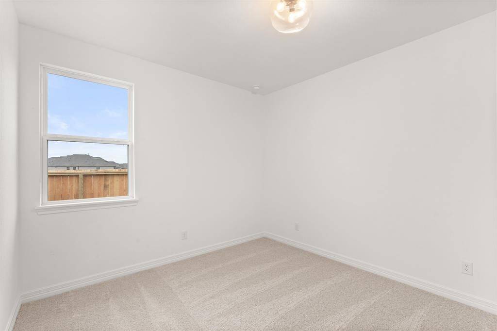 Your secondary bedroom features plush carpet, fresh paint, closet, and a large window that lets in plenty of natural lighting.