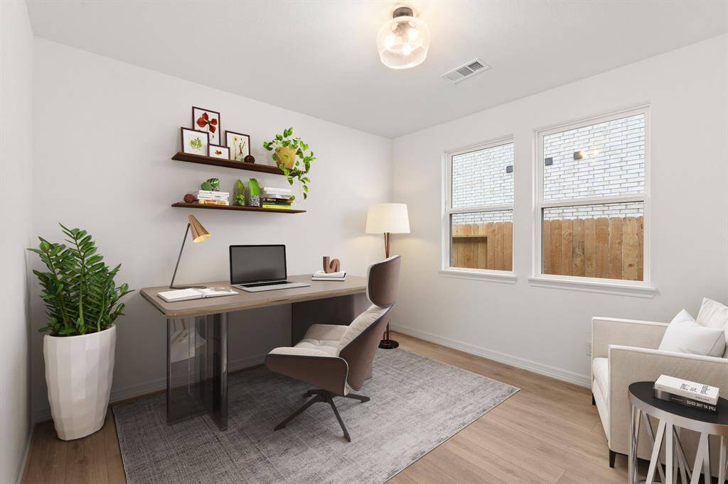 The home office features beautiful floors, large windows that give a fresh feel, this space promotes focus and creativity. Photo is virtually staged