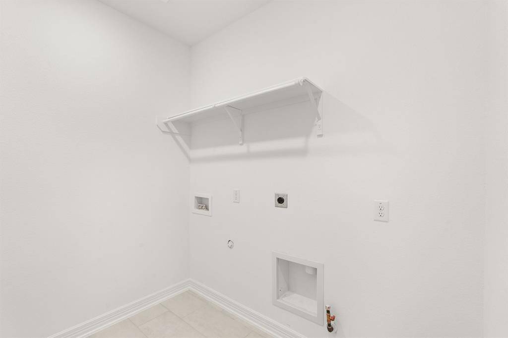 The laundry room layout is carefully planned for optimal workflow with designated areas for washing, drying, and storing.