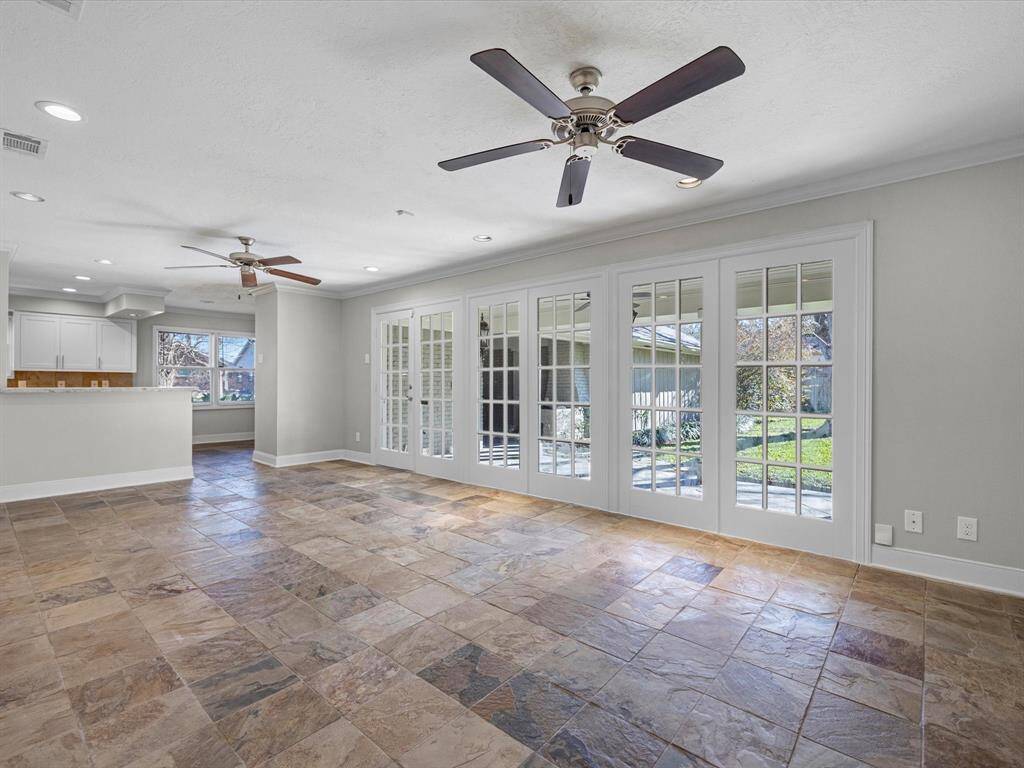 Bright and inviting den with elegant French doors opening to the outdoors.