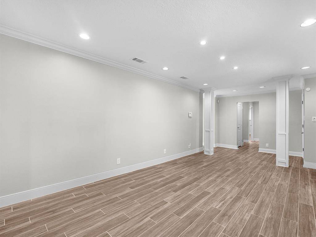 Spacious and inviting dining area with elegant flooring and recessed lighting.
