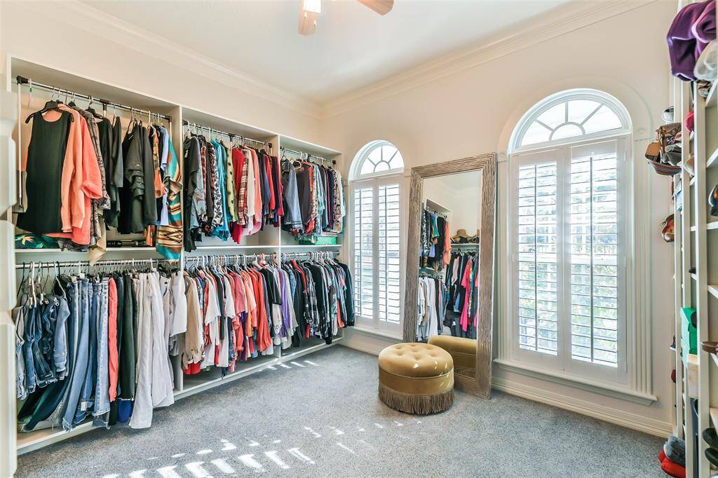 Main house primary walk in closet with built ins and pull down clothin rack. This is only one of the primary closets