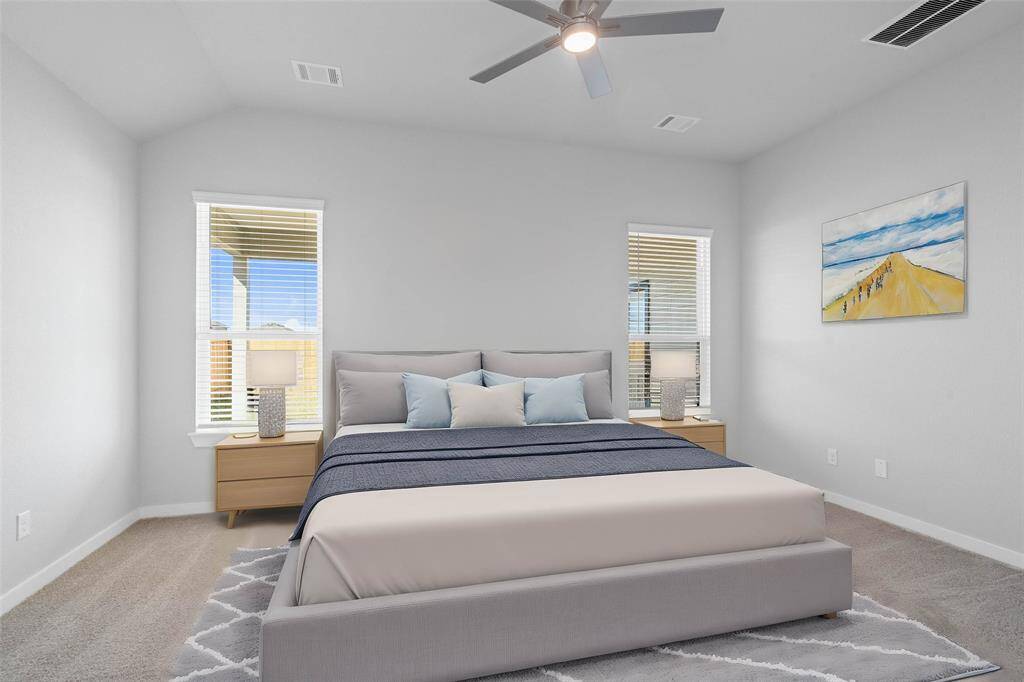 Come and unwind after a long day in this magnificent primary suite! This spacious room features plush carpet, warm paint, high ceilings, ceiling fan and large windows with privacy blinds.