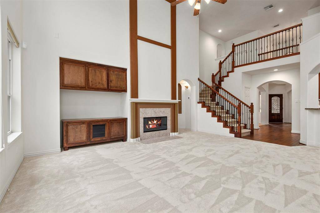 Wood accents and a cozy gas log fireplace create a warm and inviting atmosphere.