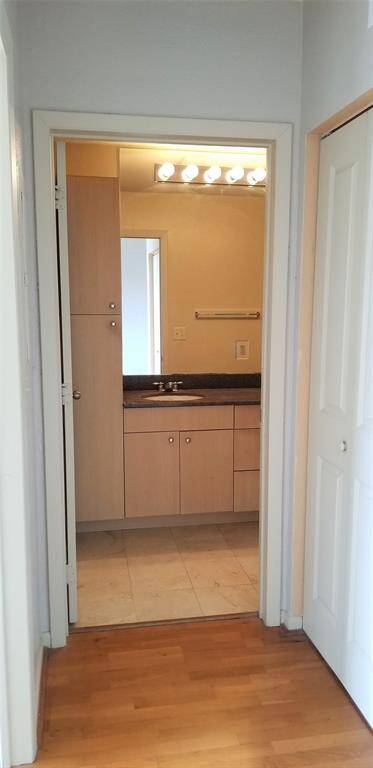 Hallway to full bath. Doors on the right open to full sized washer and dryer included.