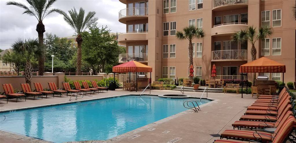 Outdoor pool with hot tub and multiple grilling stations