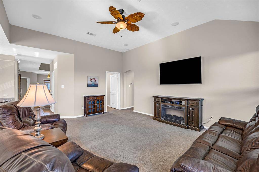 Living room leading to utility room and primary.