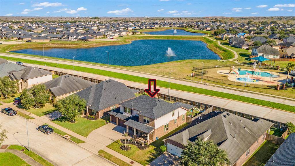 Aerial of the home and nearby lake and swimming pool.