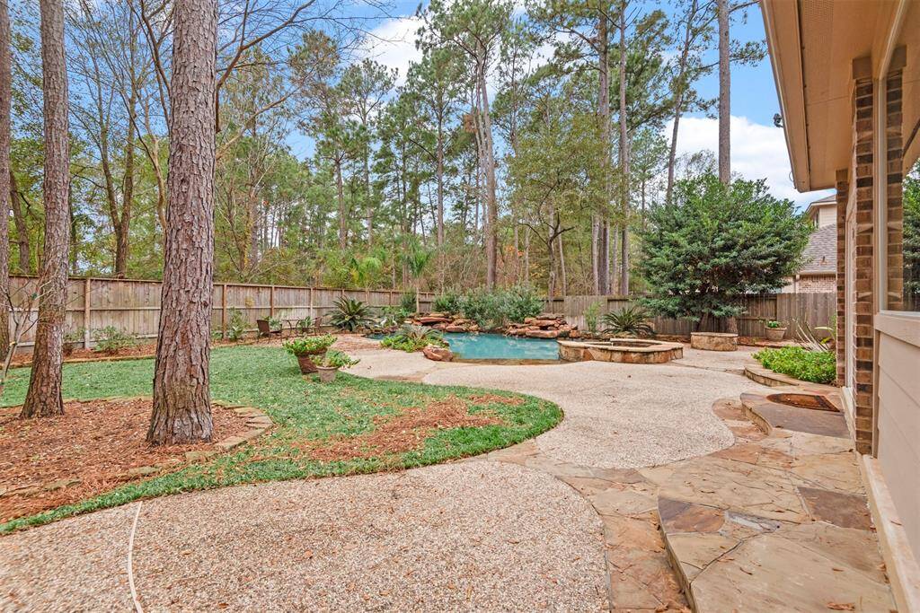 Discover your serene retreat with a beautifully landscaped backyard featuring a sparkling pool and lush greenery, perfect for relaxation and entertaining.