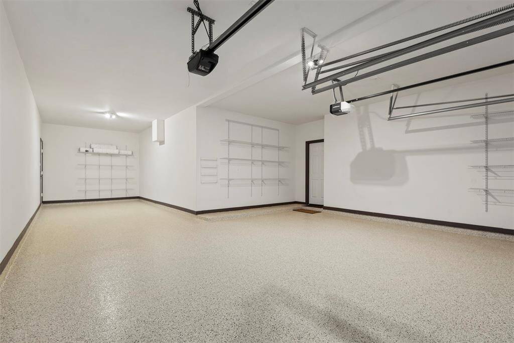 Spacious 3-car tandem garage with sleek epoxy flooring.