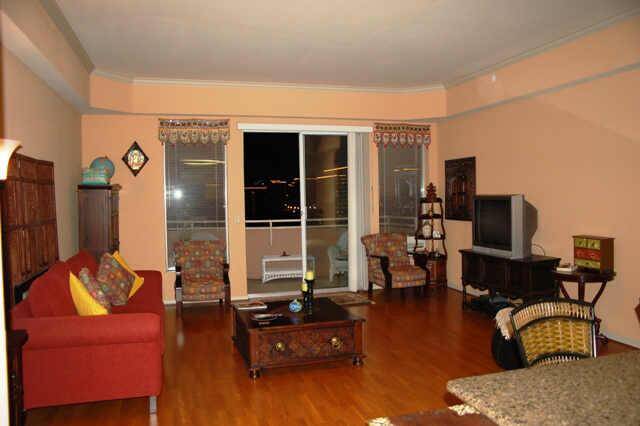 Main living area with hardwood flooring, high ceilings, sliding glass door to outdoor deck. Updated interior photos to come.