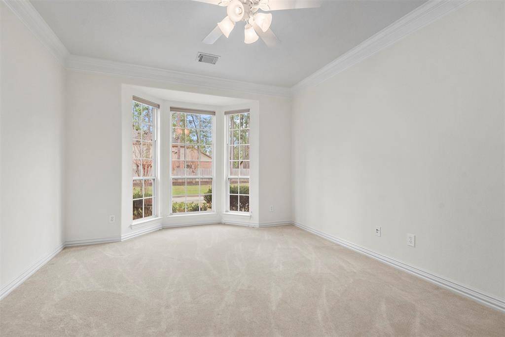 Bright study featuring elegant bay windows.
