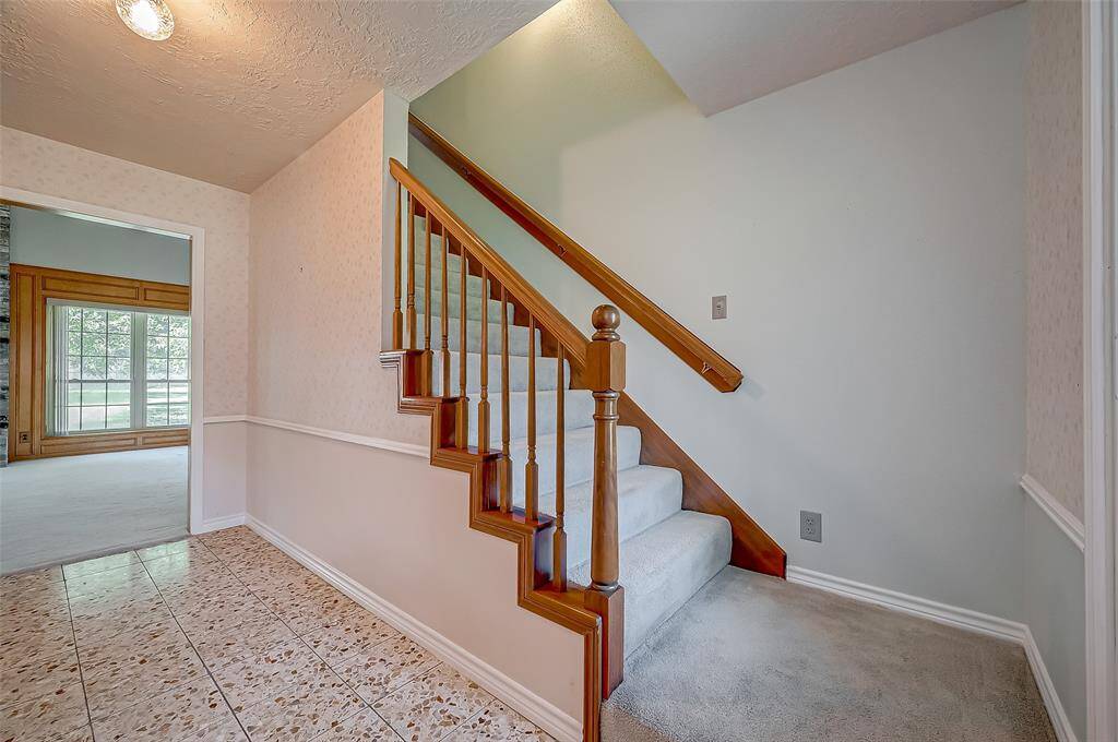 The staircase to the second floor is conveniently located off the foyer. In 2010, the HVAC system was replaced with a Carrier 15 SEER, 5-ton unit.
