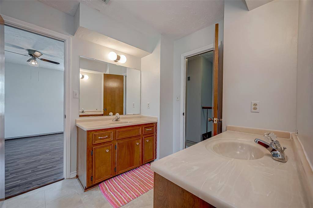 The second-floor shared bathroom, with connecting doors to both Bedroom #2 and Bedroom #3, features two vanities, each with a single sink and cultured marble countertop. The bathroom also includes a tile floor for easy maintenance.