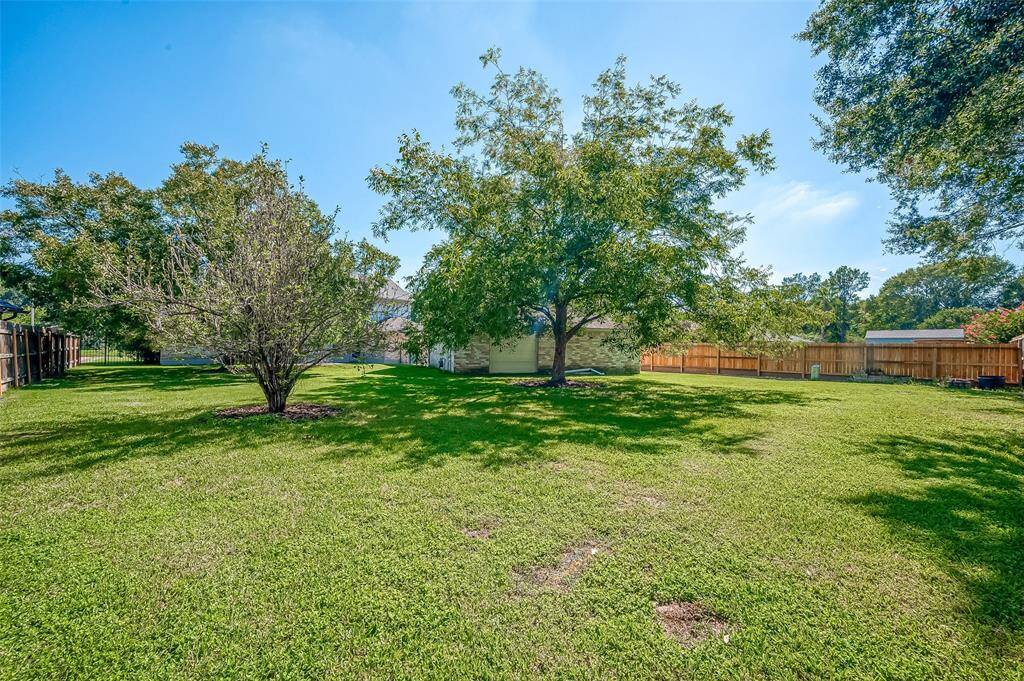 From the back of the lot, you’ll notice the single rear door of the detached 3-car garage. This convenient feature allows for easy storage of a trailer or boat in the backyard, offering both accessibility and security for your recreational vehicles.