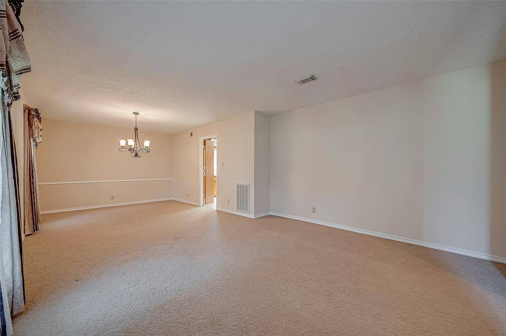 The formal living room measures 13.6 x 11.11, offering versatile use. Many families are installing French doors to transform this space into a playroom or gameroom, while repurposing the dining area into a home office. The room's generous wall space provides ample opportunity for displaying furniture and personal touches.