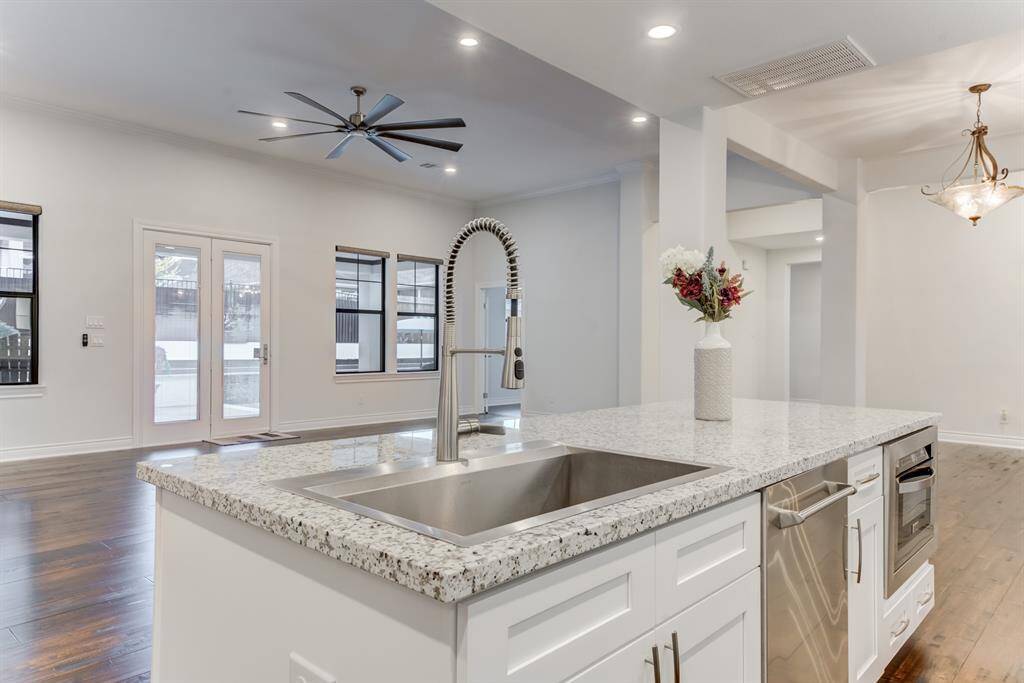 The cook enjoys views out to the backyard space through large windows and a set of French doors leading outside.