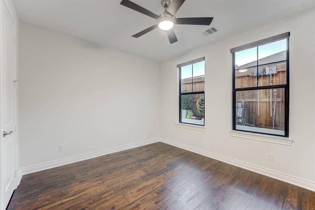 Another of the secondary bedrooms downstairs. Noticing the wood floors continue here.