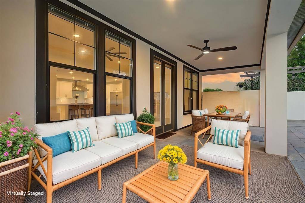 Virtually staged - This covered patio area is an extension of the great room, and overlooks the sparkling pool.