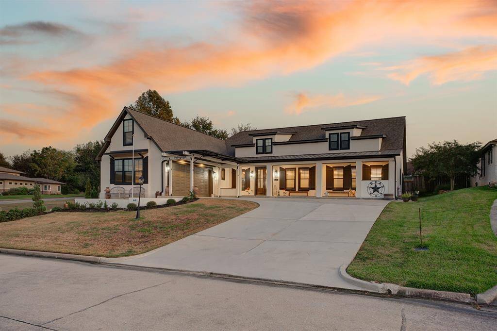 Modern elevation, featuring a blend of traditional and contemporary design elements, set in a luxurious lake & golf course community.