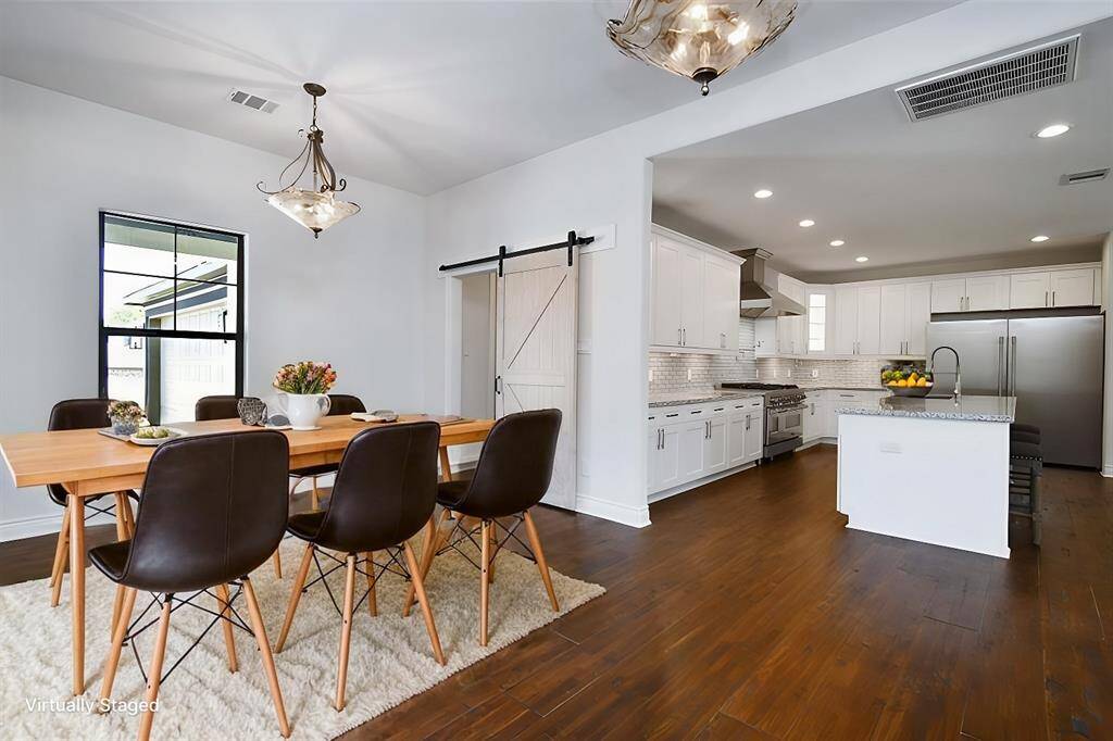 Virtually staged - Featuring a center island and a sliding barn door that adds character to the room.