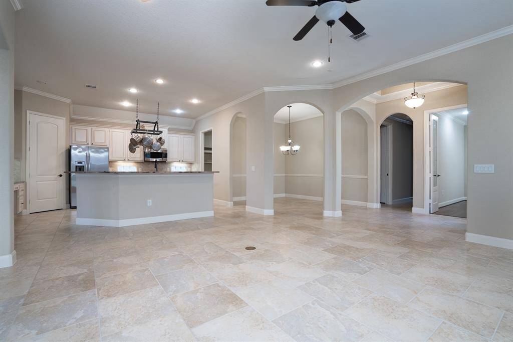Current view of family room. Large tile flooring.