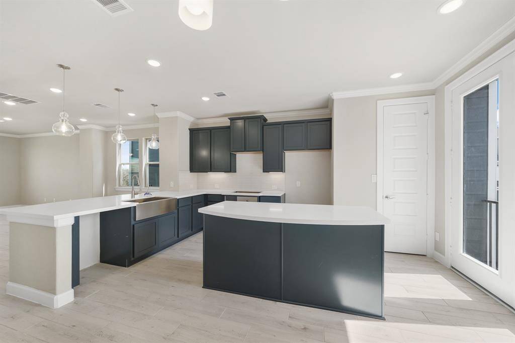 Stylish kitchen with quartz countertops and maple cabinets