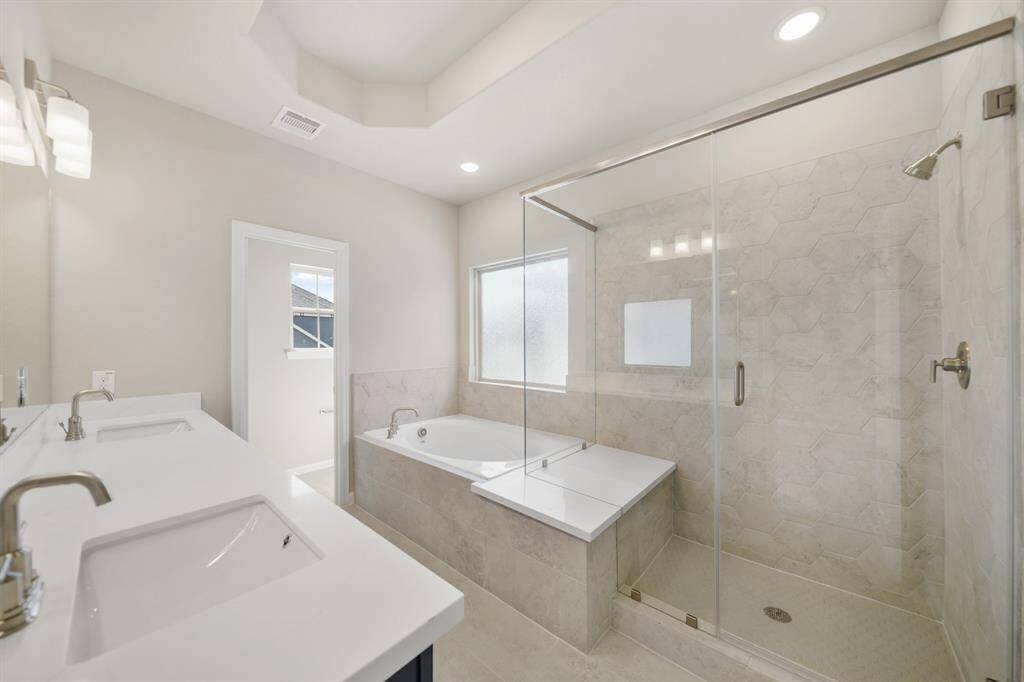 Owner's bath with soaker tub and separate shower