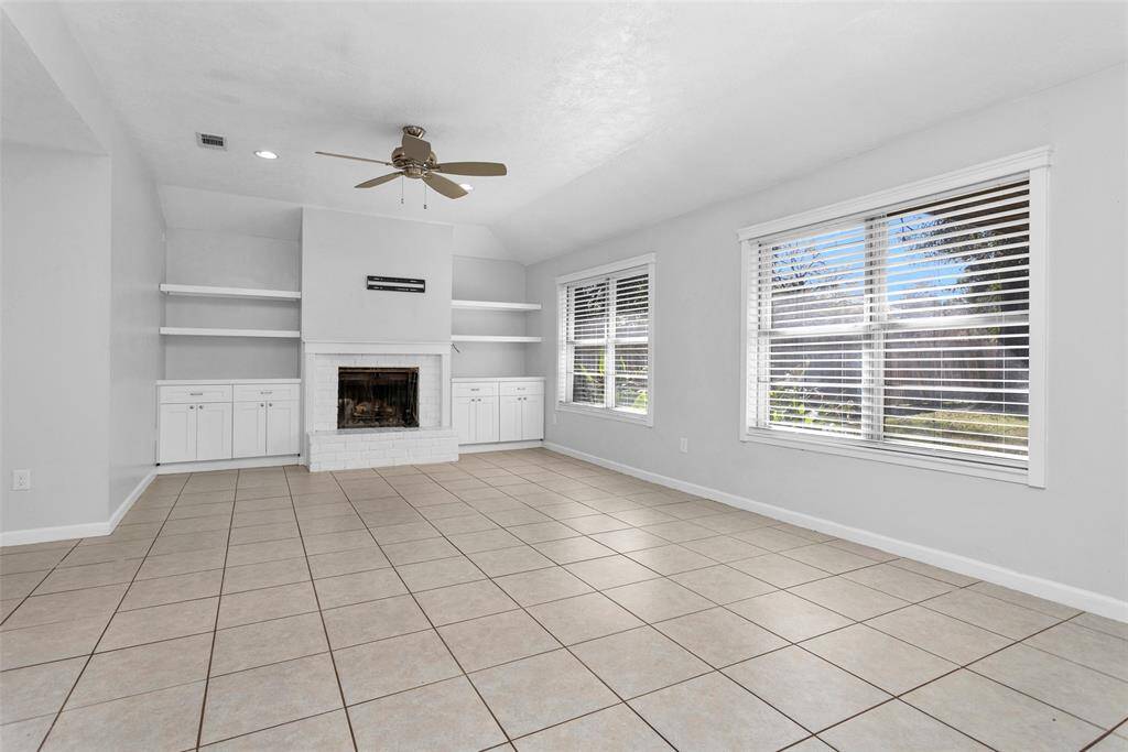 Living room boasts a cozy fire place with built ins that add plenty of character.