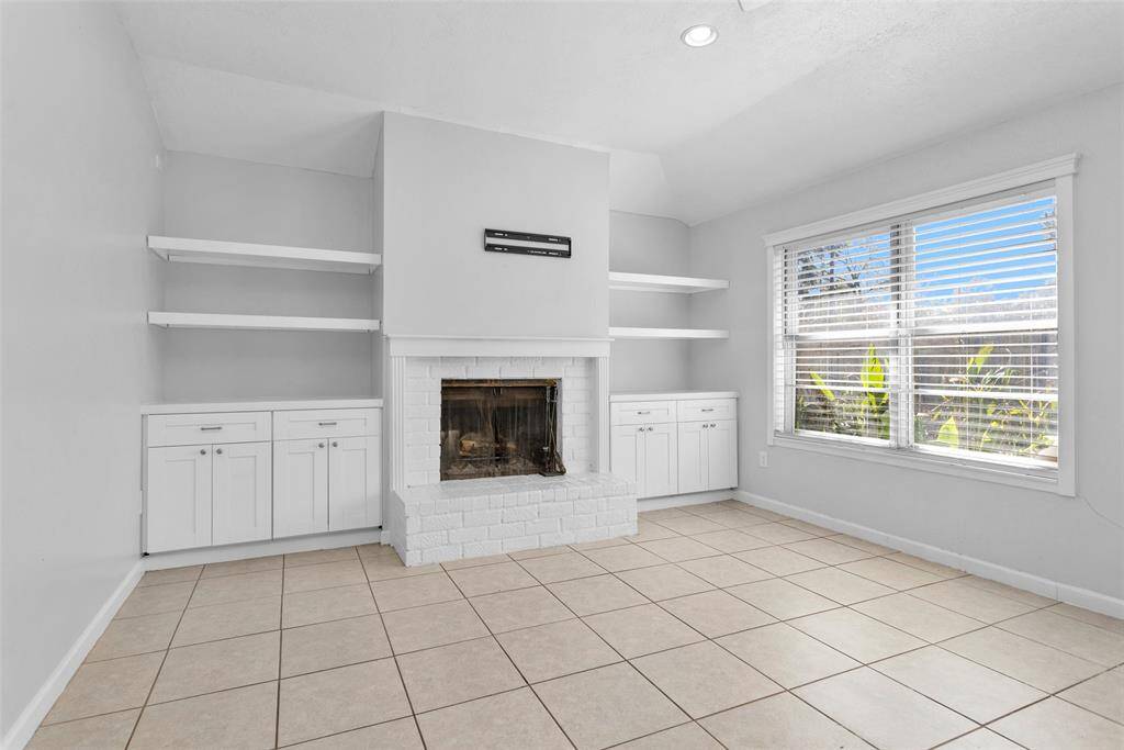 Living room boasts a cozy fire place with built ins that add plenty of character.