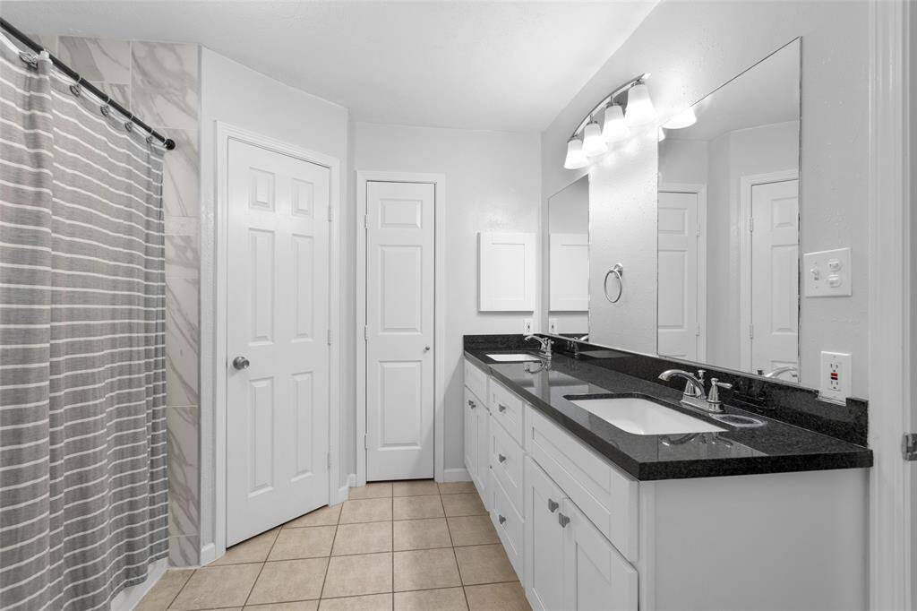Primary bathroom with 2 sinks and 2 closets.