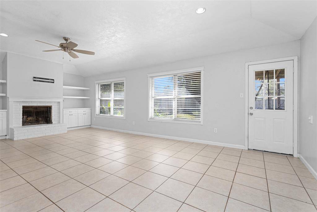 Living room boasts a cozy fire place with built ins that add plenty of character.