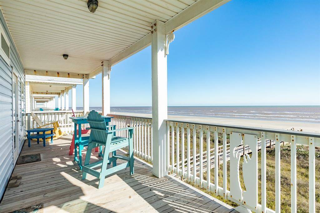 Spacious beachfront covered deck with beachfront views, featuring colorful outdoor seating for relaxation and entertainment.