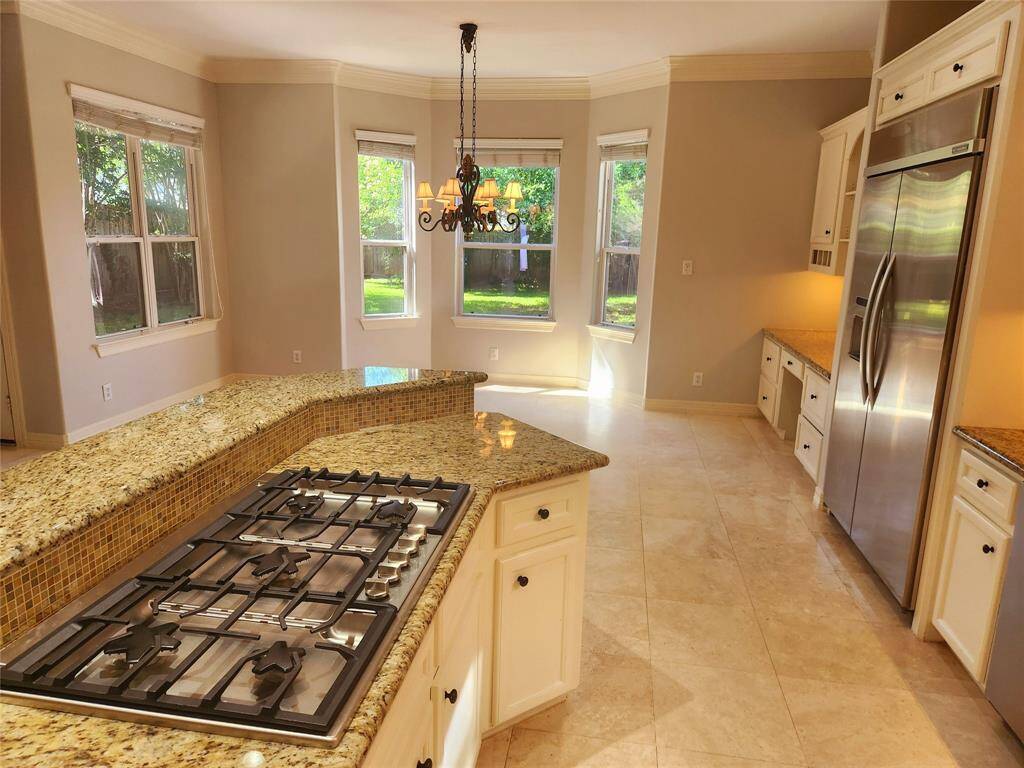 View of the new cook top in the kitchen, breakfast area in the background.