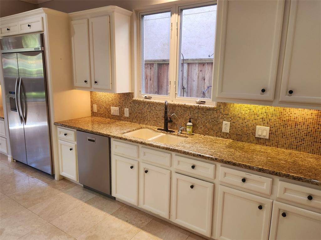 Kitchen sink area, lot of counter space and cabinet storage.