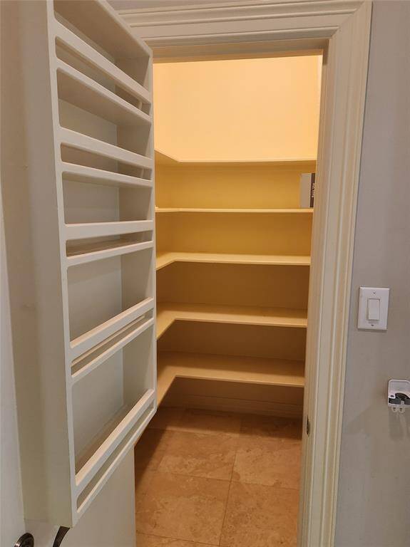 Walk-in pantry within the butler's pantry area.