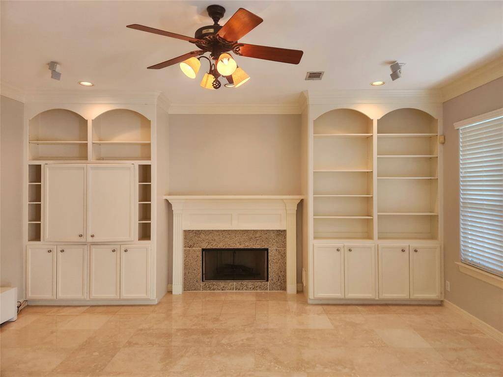 Great room and fireplace view from the open kitchen area. Nice built-ins too.