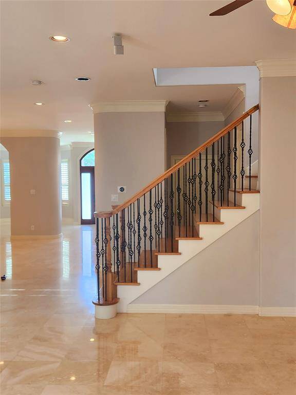 View of staircase and front entry hallway from the great room.
