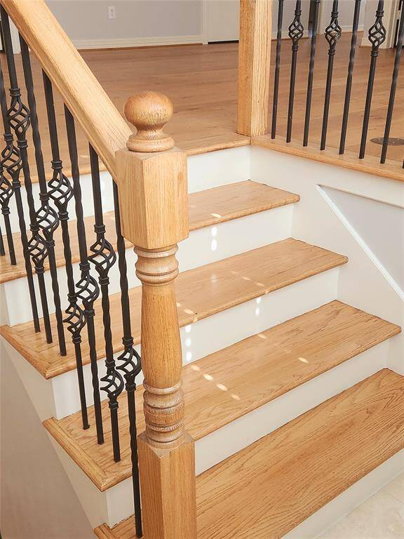 Staircase to second floor. Powder room is located to the left of the stairs just past the garage access hallway.